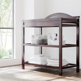 graco story espresso changing table with changing essentials on both shelves in nursery
