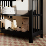 Close-up view of a black changing table in the left corner
