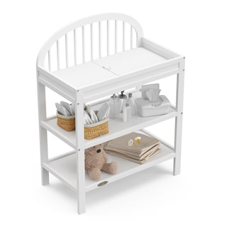 white changing table with nursery supplies