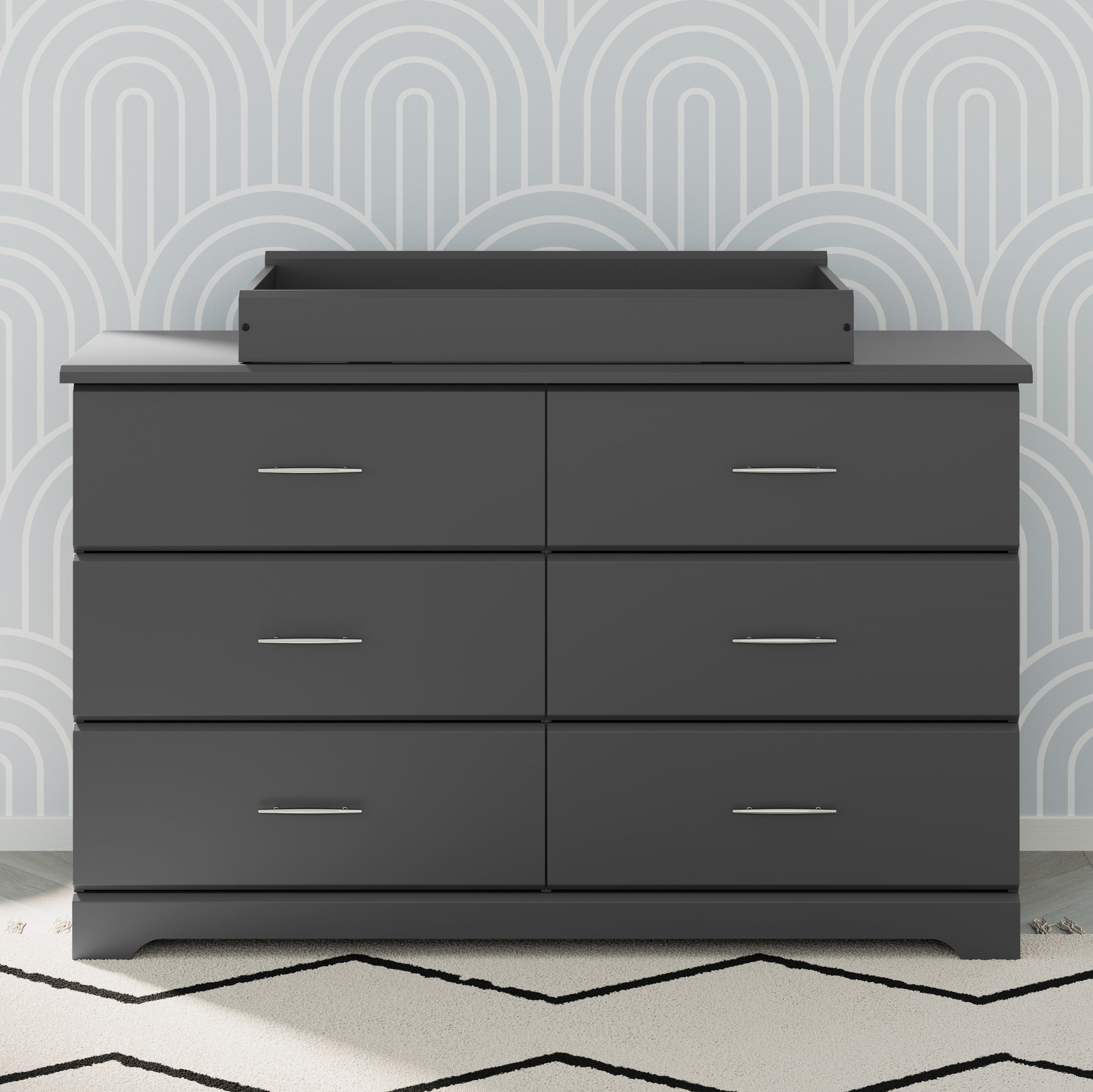 nest gray changing topper on top of brookside 6 drawer gray dresser in nursery
