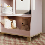 storkcraft modern convertible changing table blush with driftwood closeup of storage and base in nursery with baby items inside