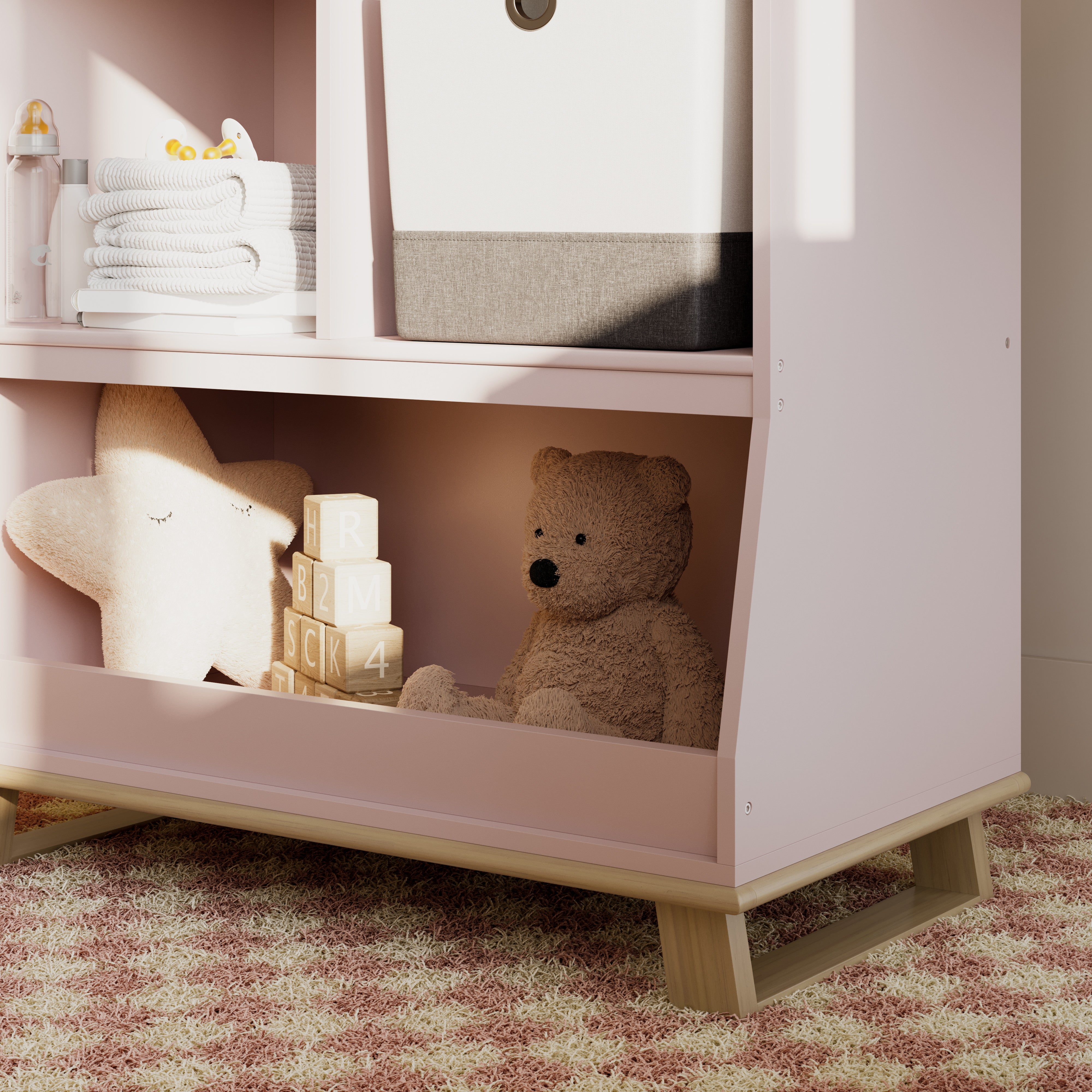 storkcraft modern convertible changing table blush with driftwood closeup of storage and base in nursery with baby items inside