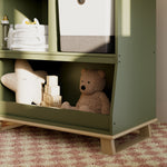 storkcraft modern convertible changing table olive with driftwood closeup of storage and base in nursery with baby items inside