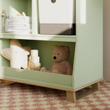 storkcraft modern convertible changing table sage with driftwood closeup of storage and base in nursery with baby items inside