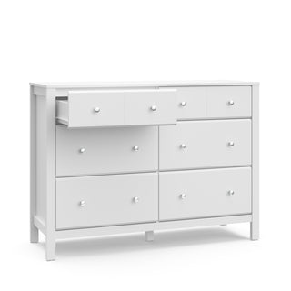 angled view of white 6 drawer dresser with one open drawer