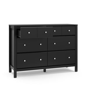 angled view of black 6 drawer dresser with one open drawer
