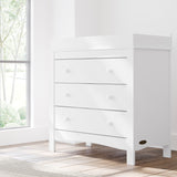noah 3 drawer chest with topper in white finish in nursery by window