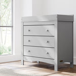 noah 3 drawer chest with topper in pebble gray finish in nursery by window