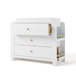 Angle view of Read-with-Me 3 drawer chest with bookshelves and changing topper in white with driftwood with top drawer open