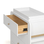 Close up drawer view of Read-with-Me 3 drawer chest with bookshelves and changing topper in white with driftwood with top drawer open showing interlocking drawer mechanism