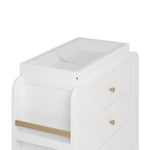Close up view of Read-with-Me 3 drawer chest's changing topper in white with driftwood with changing pad