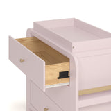 Close up drawer view of Read-with-Me 3 drawer chest with bookshelves and changing topper in blush with driftwood with top drawer open showing interlocking drawer mechanism