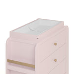 Close up view of Read-with-Me 3 drawer chest's changing topper in blush with driftwood with changing pad