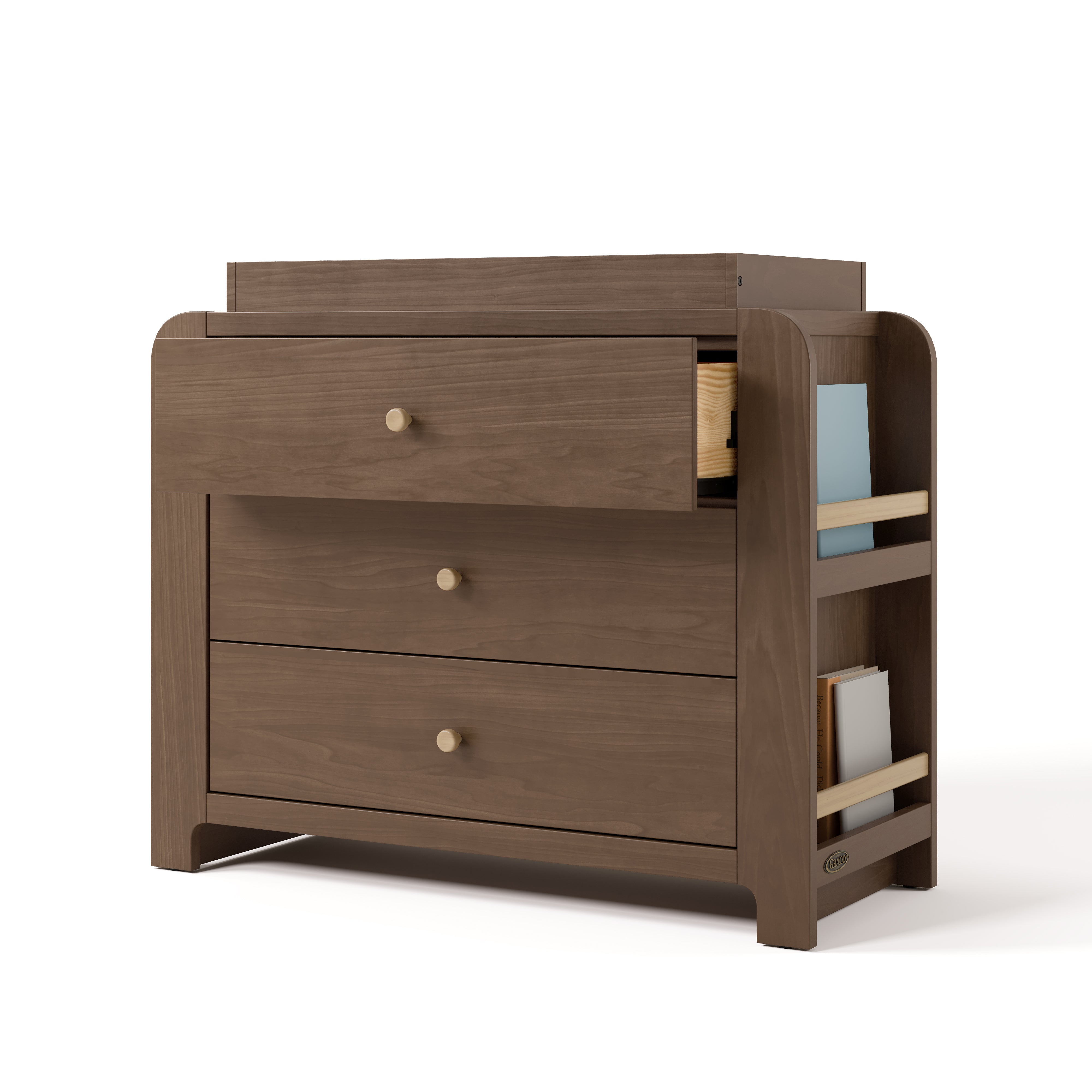 Angle view of Read-with-Me 3 drawer chest with bookshelves and changing topper in hazelnut with driftwood with top drawer open