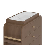 Close up view of Read-with-Me 3 drawer chest's changing topper in hazelnut with driftwood with changing pad