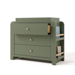 Angle view of Read-with-Me 3 drawer chest with bookshelves and changing topper in olive with driftwood with top drawer open