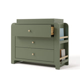 Angle view of Read-with-Me 3 drawer chest with bookshelves and changing topper in olive with driftwood with top drawer open