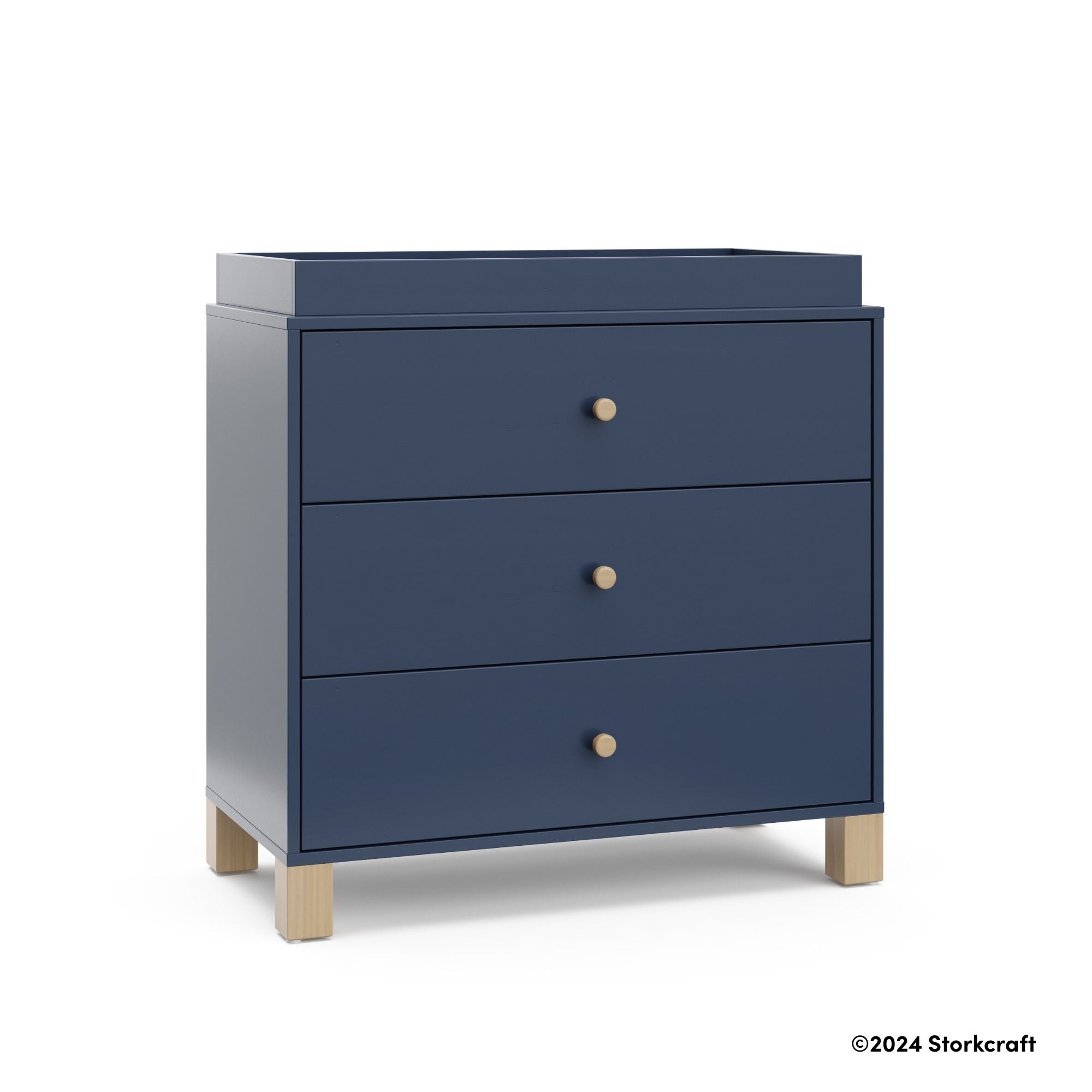 California midnight blue with driftwood 3 drawer chest with changing topper with 2024 Storkcraft copyright on bottom right