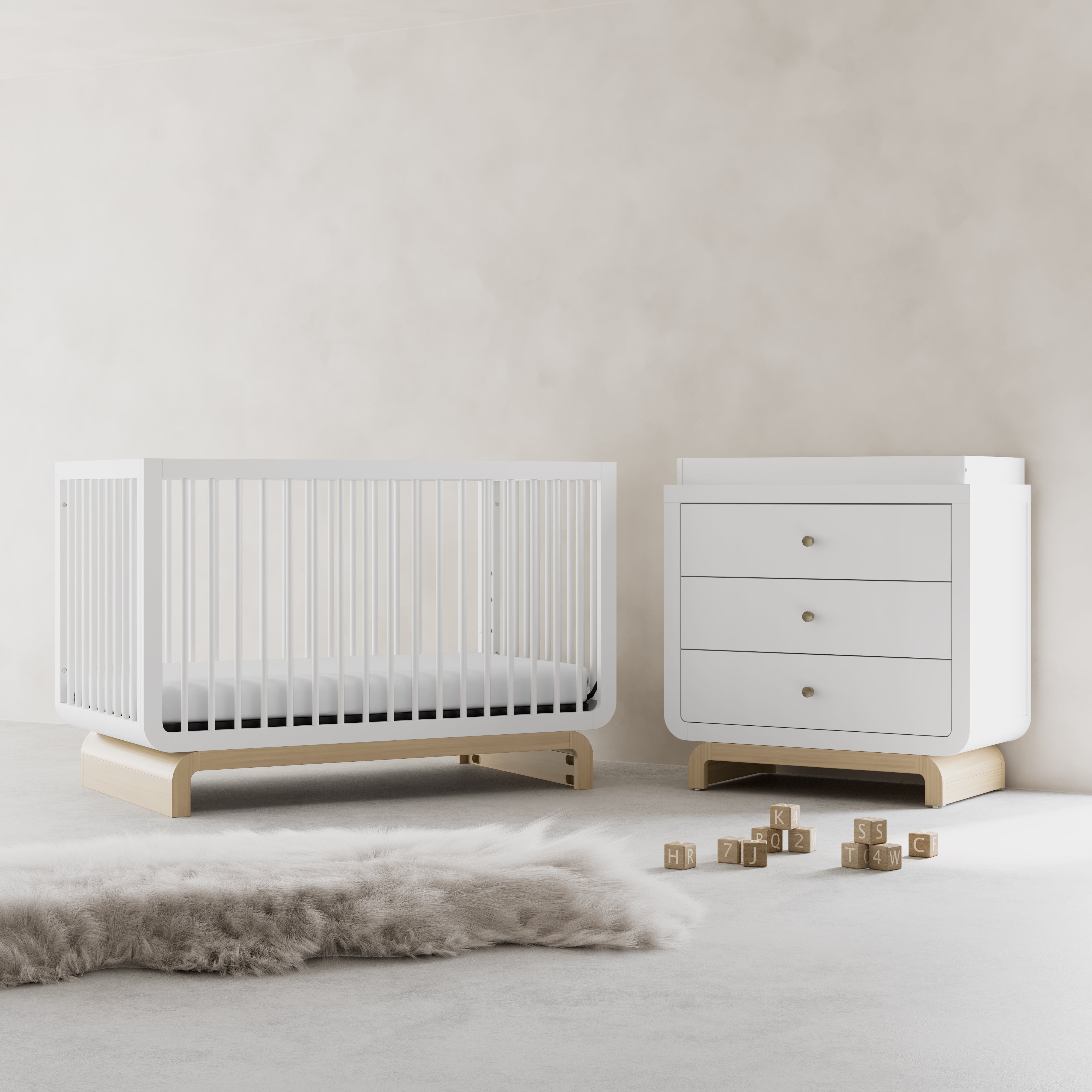 Santorini white with driftwood 3 drawer chest with changing topper in a nursery next to crib
