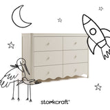 Storkcraft Casablanca frosted oat 6 drawer dresser angle view with black cartoon drawings