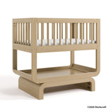 Santorini driftwood bassinet with 2025 Storkcraft copyright on bottom right