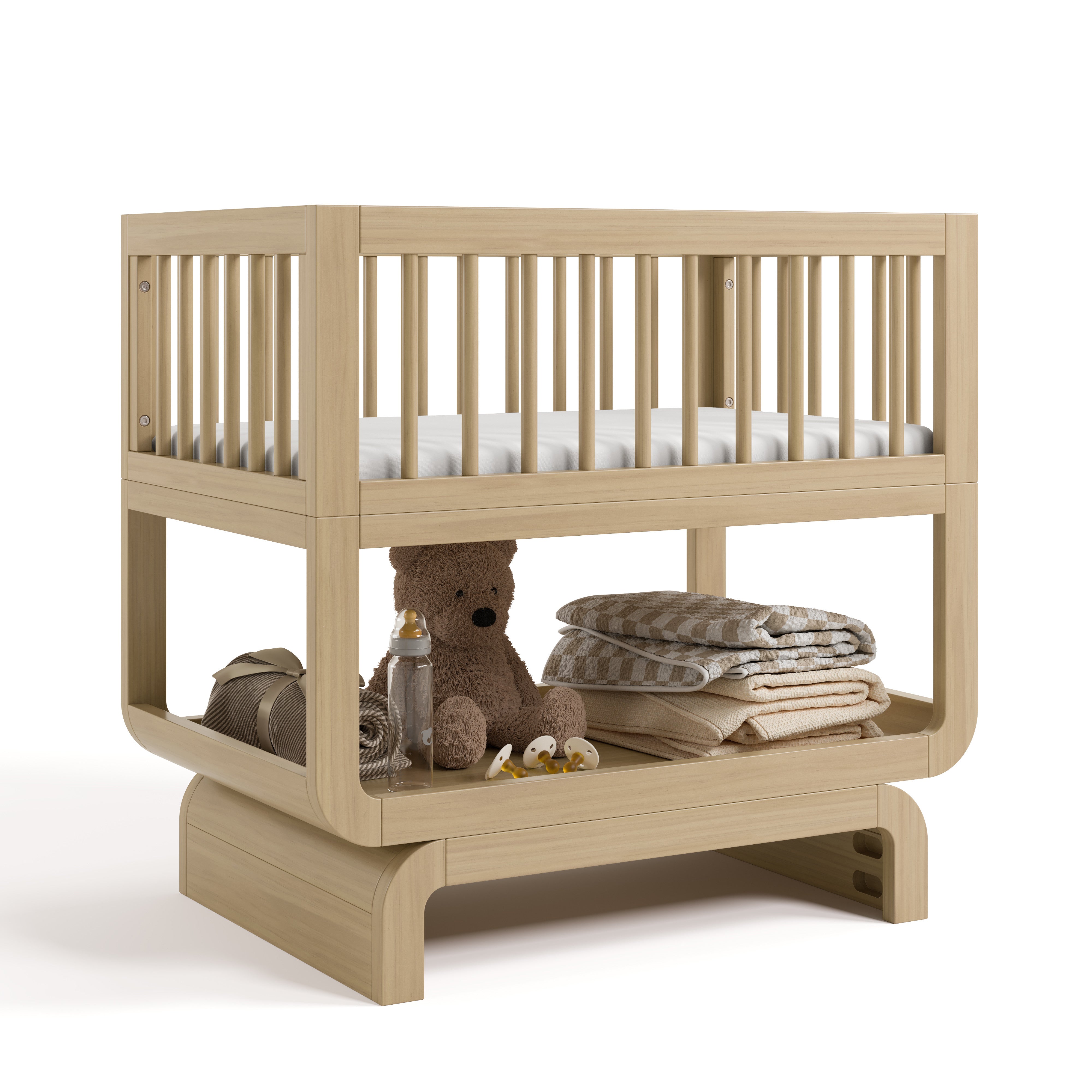 Santorini driftwood bassinet angle view with baby items on bottom