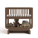 Santorini hazelnut bassinet front view with baby items on bottom