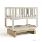 Santorini frosted oat with driftwood bassinet with 2025 Storkcraft copyright on bottom right