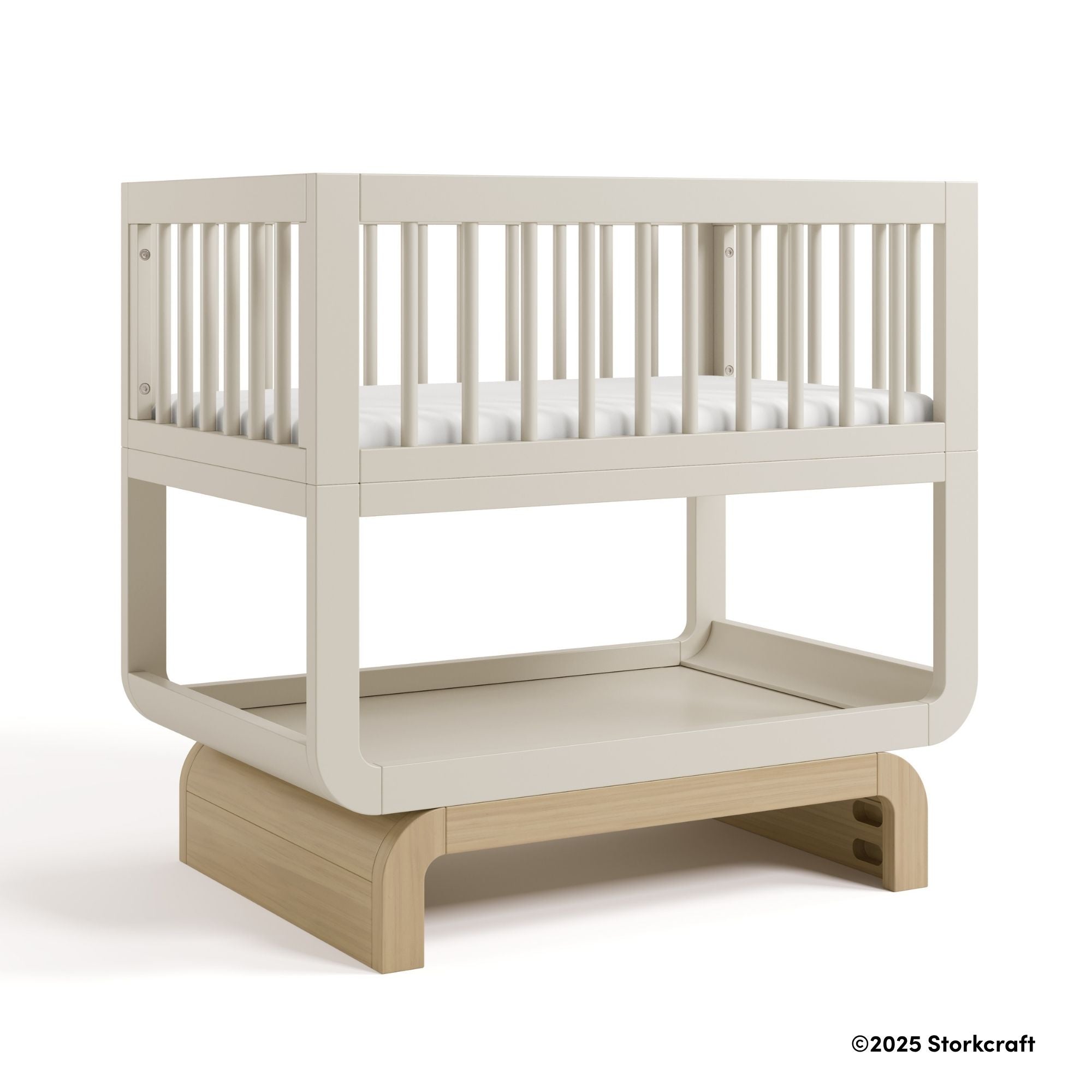 Santorini frosted oat with driftwood bassinet with 2025 Storkcraft copyright on bottom right