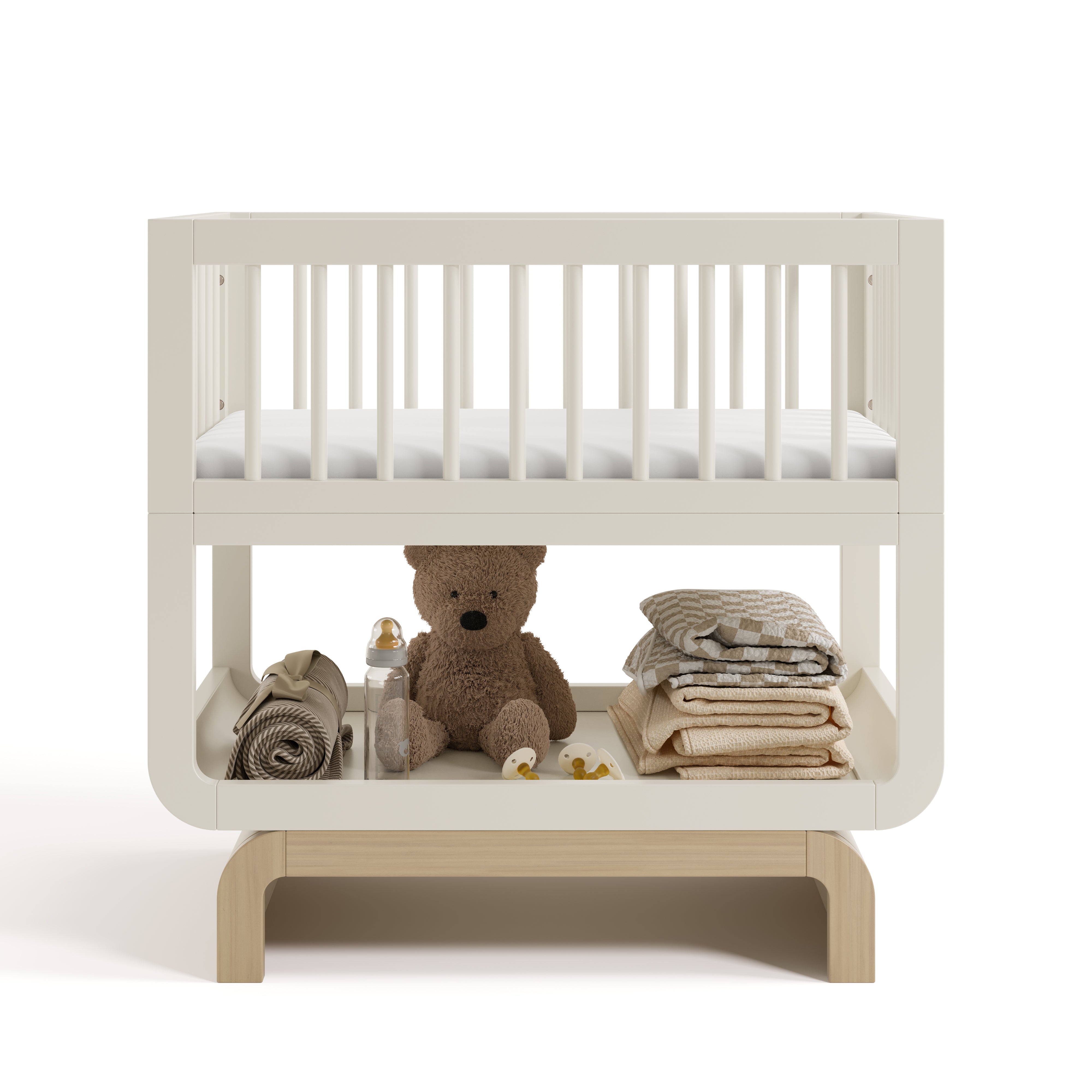 Santorini frosted oat with driftwood bassinet front view with baby items on bottom