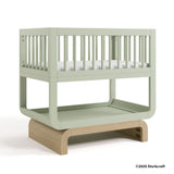 Santorini sage with driftwood bassinet with 2025 Storkcraft copyright on bottom right