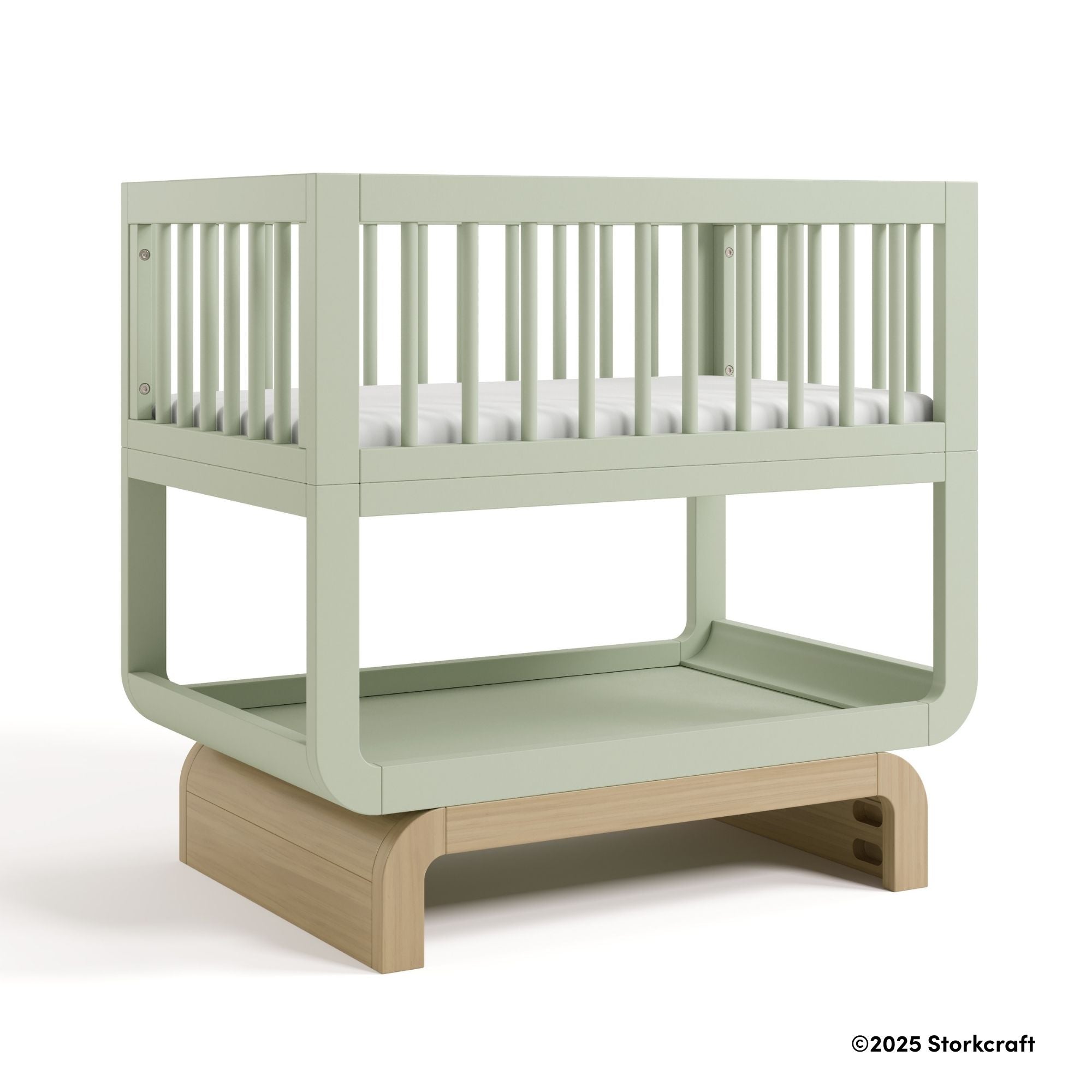 Santorini sage with driftwood bassinet with 2025 Storkcraft copyright on bottom right