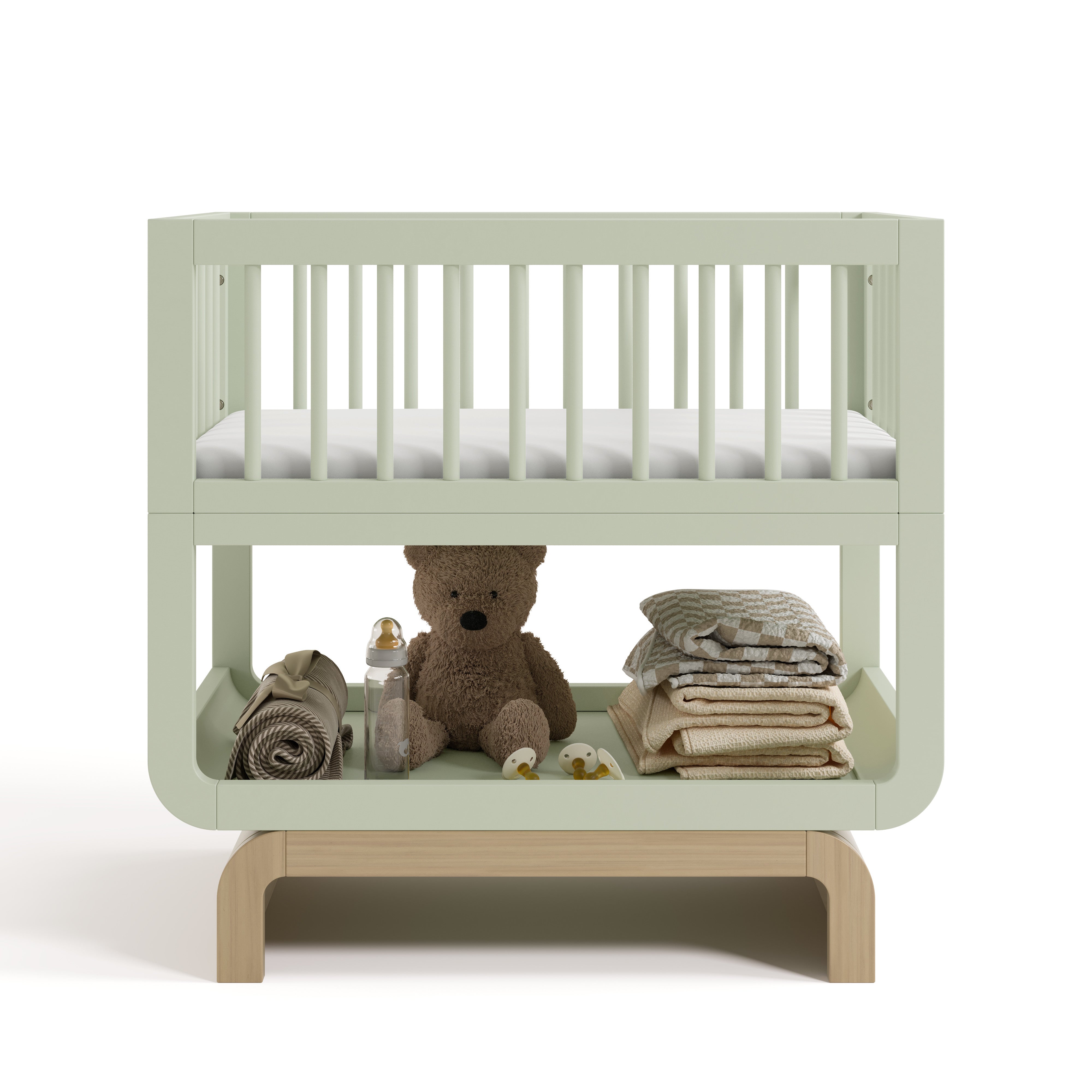 Santorini sage with driftwood bassinet front view with baby items on bottom
