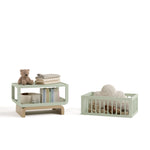 Santorini sage with driftwood bassinet converted to bookcase and toybox with baby items inside