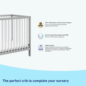 pebble gray and white mini crib with awards and certifications