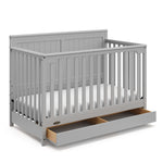 graco hadley pebble gray crib with drawer open angle view