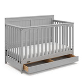graco hadley pebble gray crib with drawer open angle view