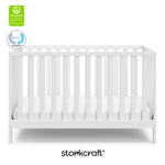 White crib with overlay text highlighting certification seals