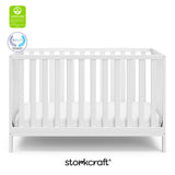 White crib with overlay text highlighting certification seals