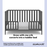 Gray crib converted into a toddler bed with overlay text highlighting product features