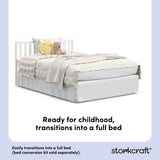 White crib converted into a twin bed, with overlay text highlighting product features.