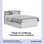 Gray crib converted into a twin bed, with overlay text highlighting product features.
