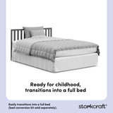 Gray crib converted into a twin bed, with overlay text highlighting product features.