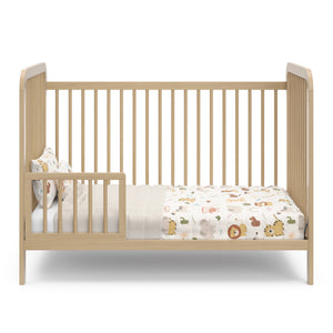 Driftwood crib in toddler bed conversion with one guardrail