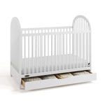 Olivia white crib with drawer open and bedding inside angle view