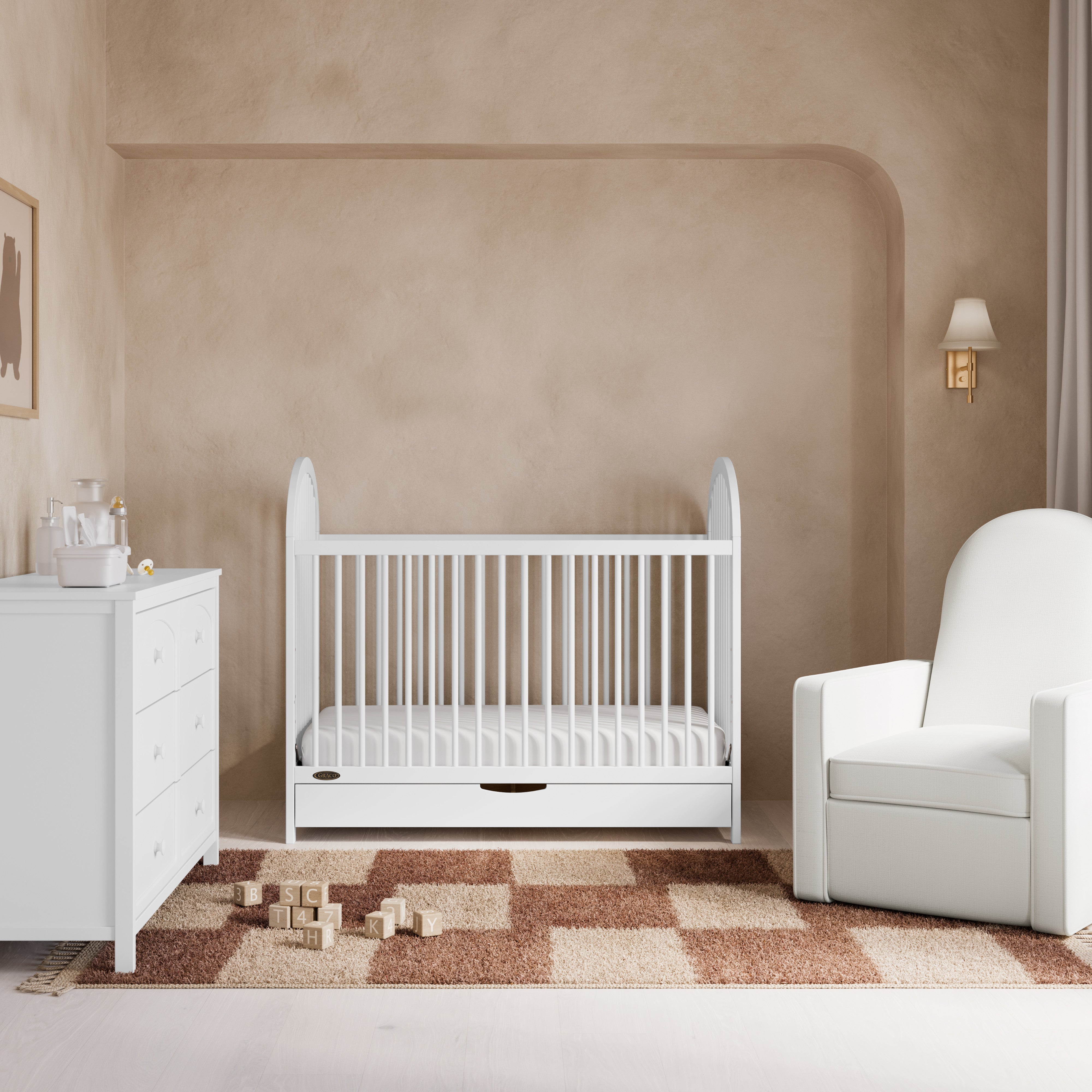 Olivia white crib with drawer in a nursery