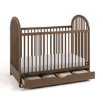 Olivia hazelnut crib with drawer open and bedding inside angle view