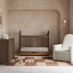 Olivia hazelnut crib with drawer in a nursery