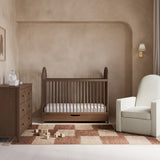 Olivia hazelnut crib with drawer in a nursery