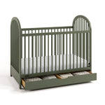 Olivia olive crib with drawer open and bedding inside angle view